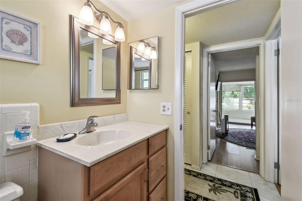 9945 47th Avenue North, Unit 208 St. Petersburg, FL 33708 - Photo 19 of 38 a bathroom with a sink and a mirror