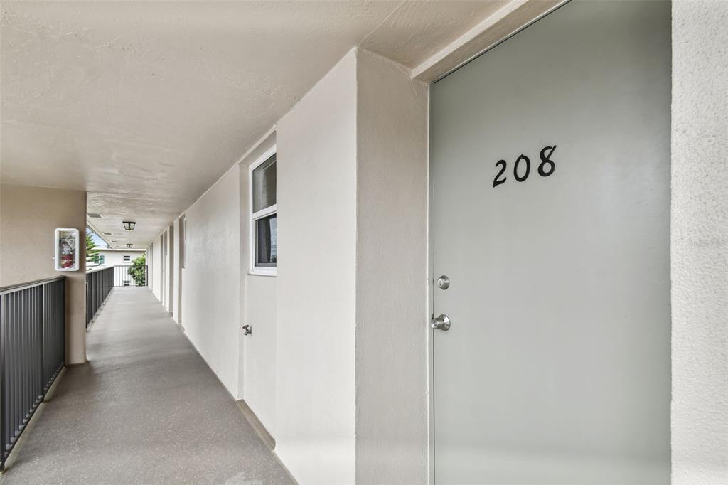 9945 47th Avenue North, Unit 208 St. Petersburg, FL 33708 - Photo 2 of 38 a hallway with a white walls