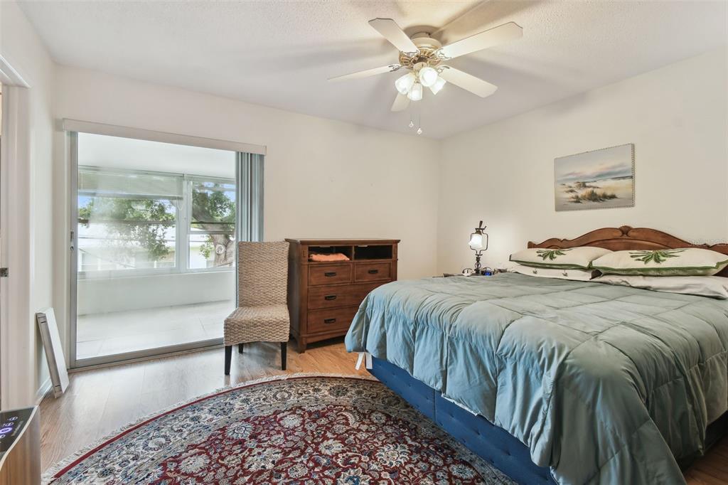 9945 47th Avenue North, Unit 208 St. Petersburg, FL 33708 - Photo 22 of 38 a bedroom with a bed and a chandelier