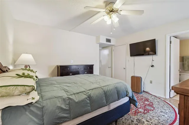 a bedroom with a bed and a flat screen tv