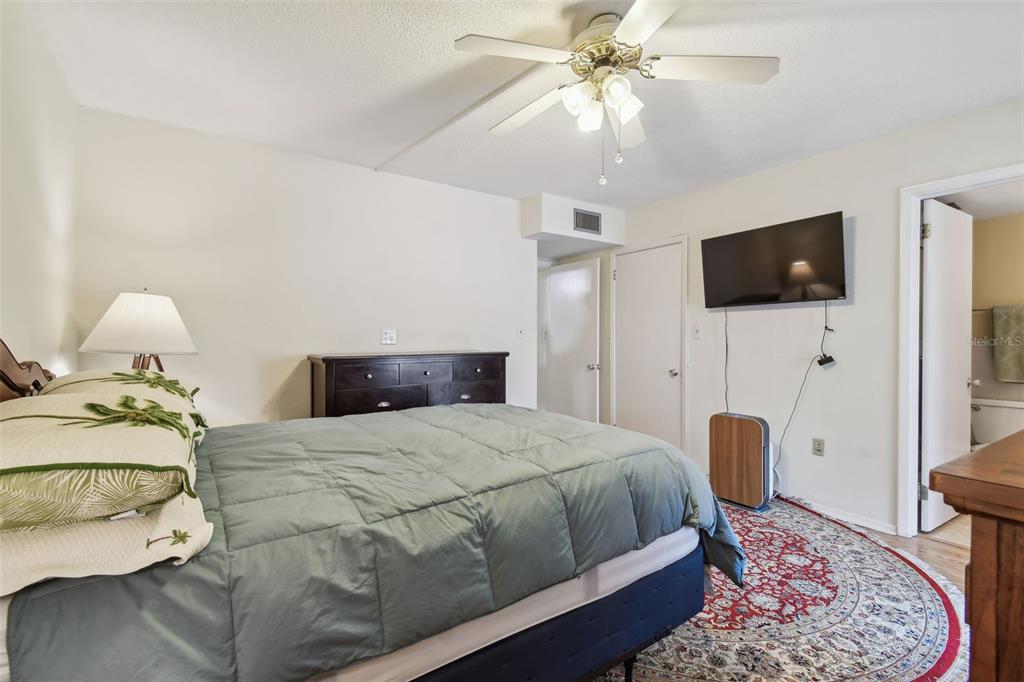 9945 47th Avenue North, Unit 208 St. Petersburg, FL 33708 - Photo 24 of 38 a bedroom with a bed and a flat screen tv