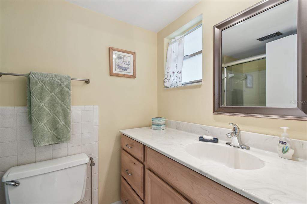 9945 47th Avenue North, Unit 208 St. Petersburg, FL 33708 - Photo 25 of 38 a bathroom with a sink and a mirror