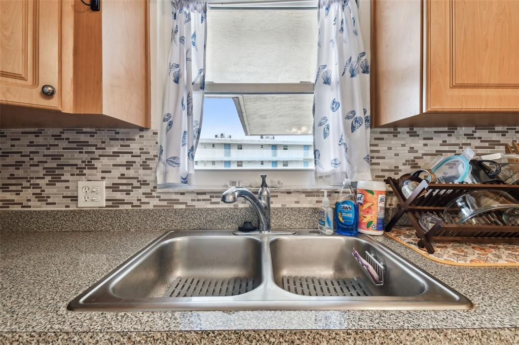 9945 47th Avenue North, Unit 208 St. Petersburg, FL 33708 - Photo 7 of 38 a kitchen sink with a granite countertop a sink and granite top