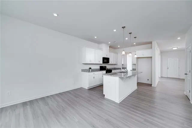 a kitchen with a white wooden cabinets and white appliances