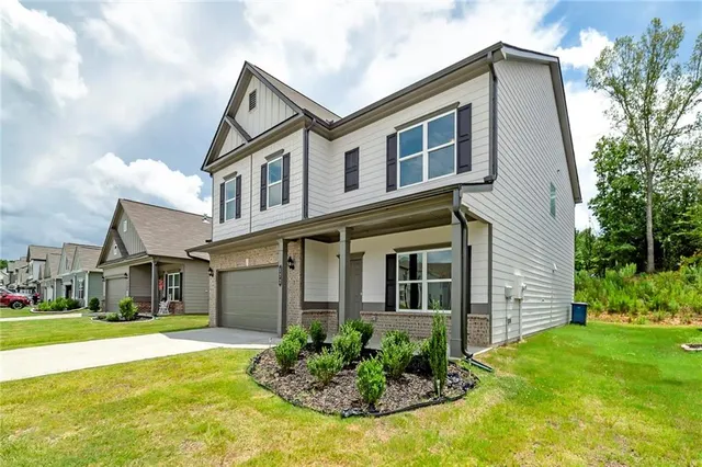 a front view of a house with a yard