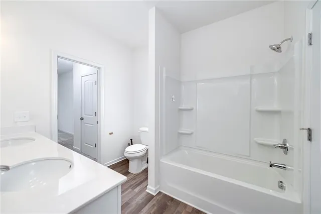 a bathroom with a tub a toilet and a sink