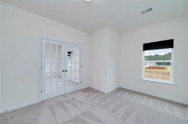an empty room with windows and closet
