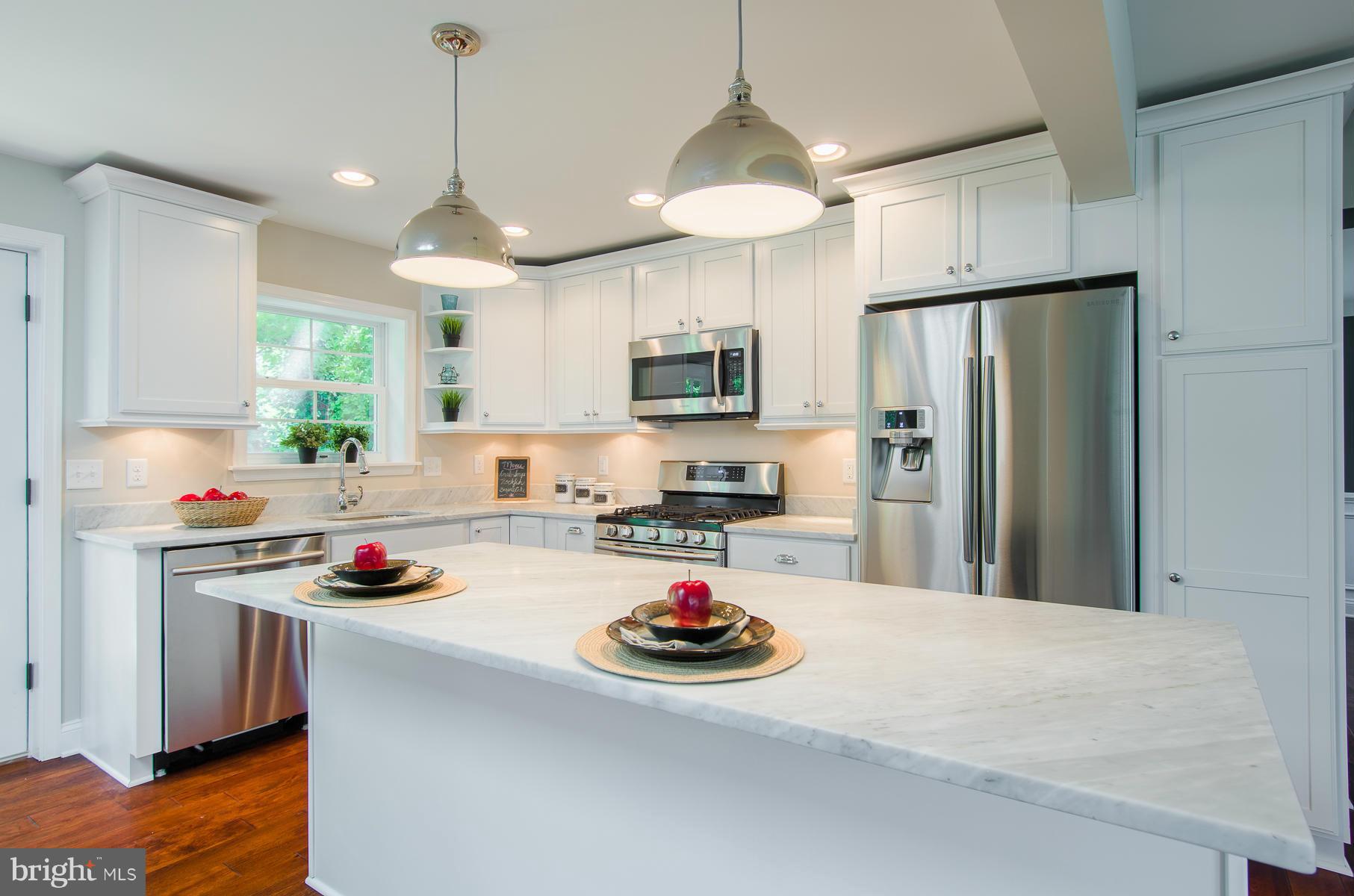 181 Hollen Road Baltimore, MD 21212 - Photo 6 of 30 a kitchen with stainless steel appliances a stove a sink a refrigerator and cabinets