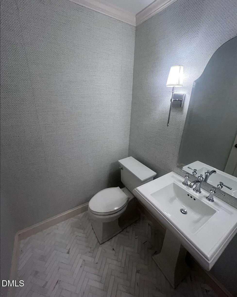 6403 Andsley Drive Raleigh, NC 27609 - Photo 11 of 21 a white toilet sitting next to a bathroom sink