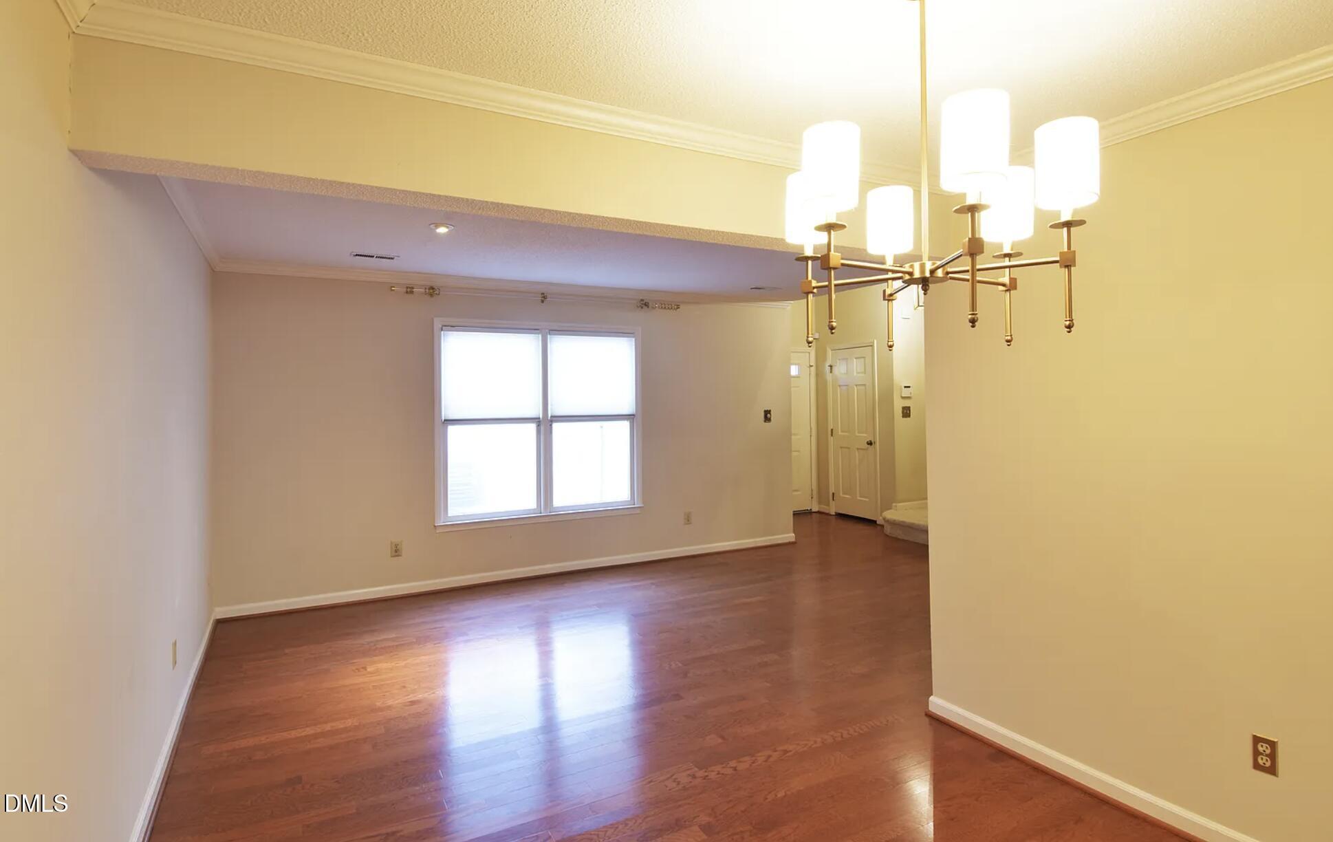 6403 Andsley Drive Raleigh, NC 27609 - Photo 13 of 21 an empty room with wooden floor and windows