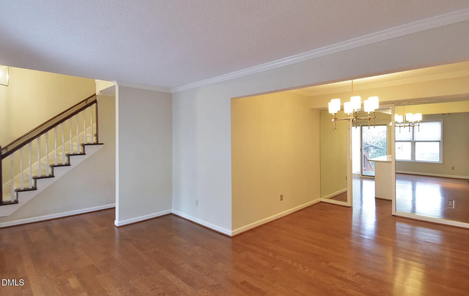 6403 Andsley Drive Raleigh, NC 27609 - Photo 14 of 21 a view of an empty room with wooden floor and a window