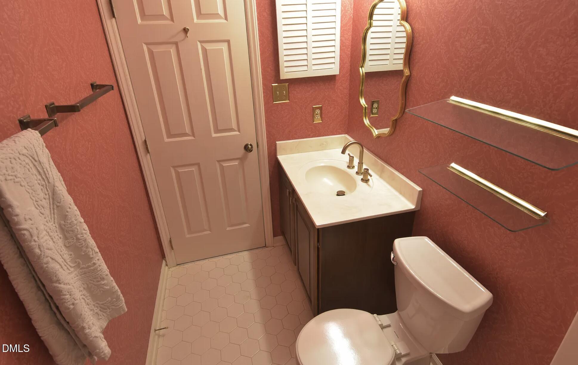 6403 Andsley Drive Raleigh, NC 27609 - Photo 15 of 21 a bathroom with a toilet sink and mirror