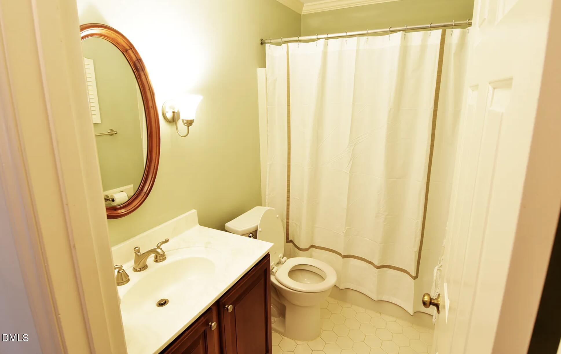 6403 Andsley Drive Raleigh, NC 27609 - Photo 16 of 21 a bathroom with a sink and a mirror