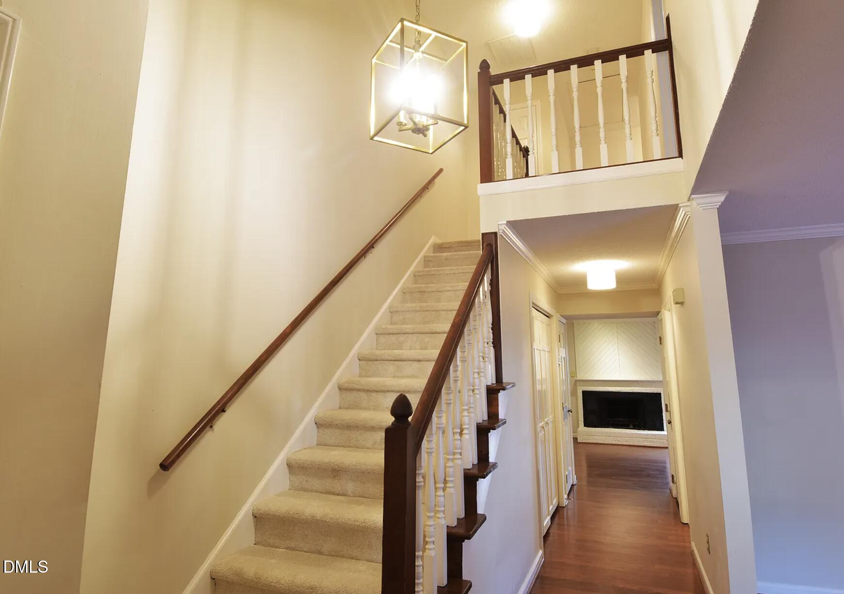6403 Andsley Drive Raleigh, NC 27609 - Photo 2 of 21 a view of a hallway with wooden floor and staircase