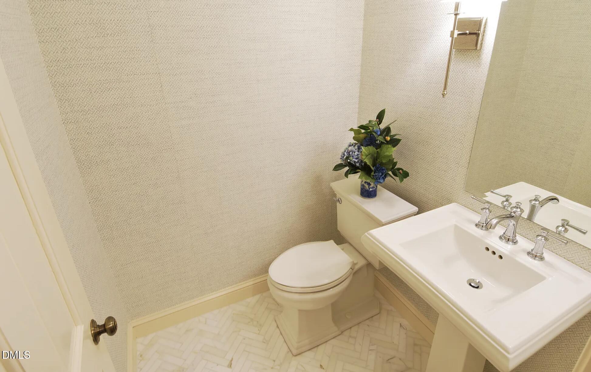 6403 Andsley Drive Raleigh, NC 27609 - Photo 3 of 21 a bathroom with a sink mirror and toilet