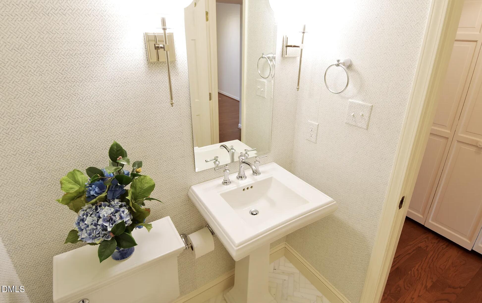 6403 Andsley Drive Raleigh, NC 27609 - Photo 4 of 21 a bathroom with a sink a mirror and a shower