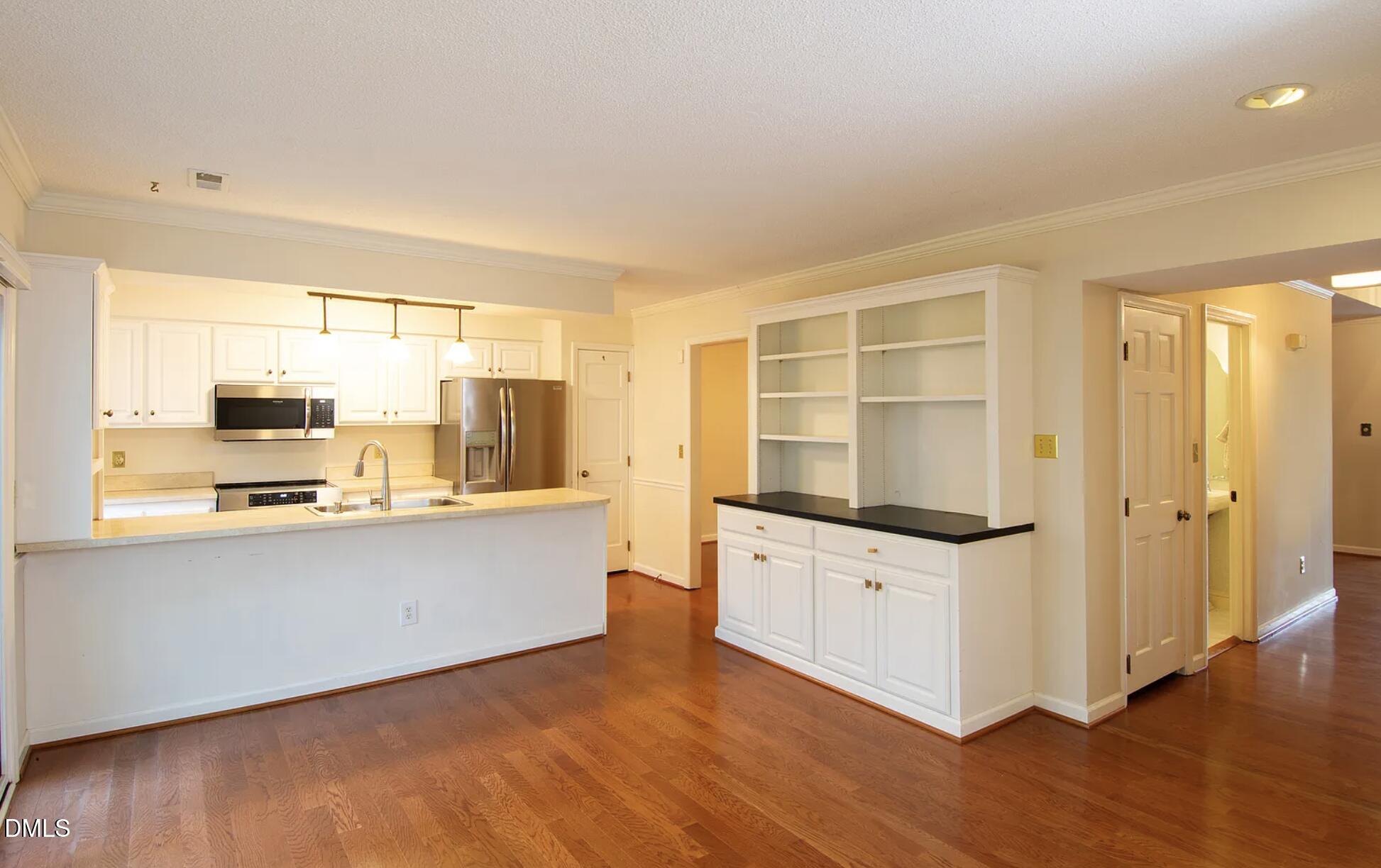 6403 Andsley Drive Raleigh, NC 27609 - Photo 6 of 21 a kitchen with stainless steel appliances a stove a sink and a refrigerator