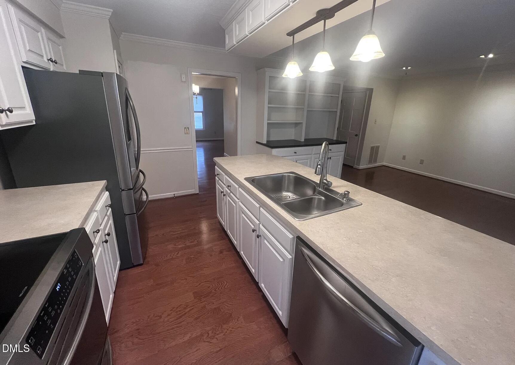 6403 Andsley Drive Raleigh, NC 27609 - Photo 8 of 21 a kitchen with a sink a counter top space stainless steel appliances and cabinets