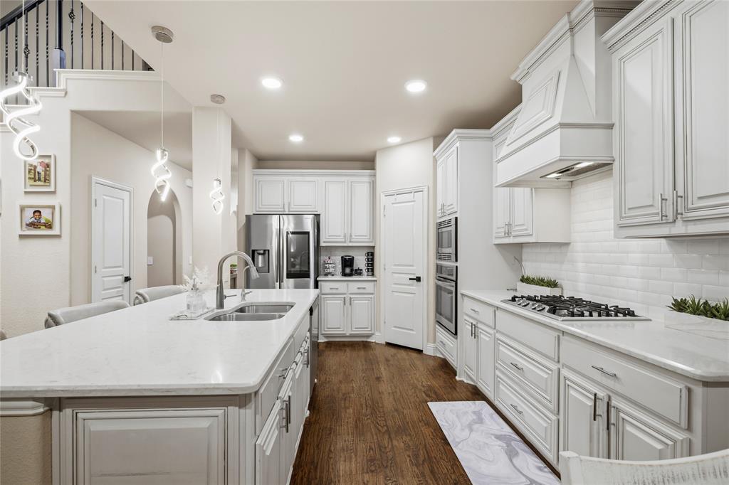 1802 Roundtree Road Forney, TX 75126 - Photo 13 of 39 a kitchen with white cabinets and appliances