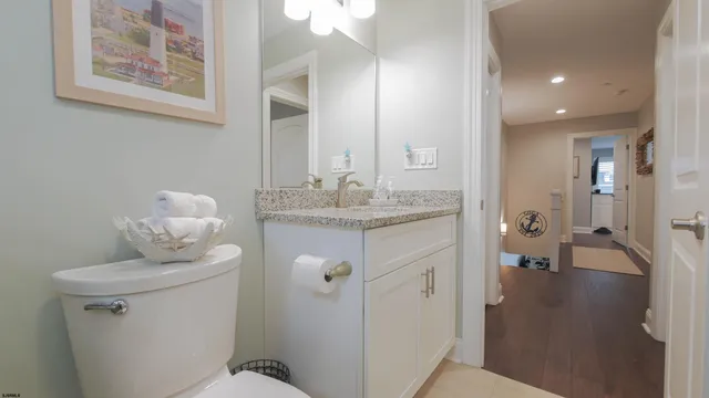 a bathroom with a sink vanity granite and a mirror