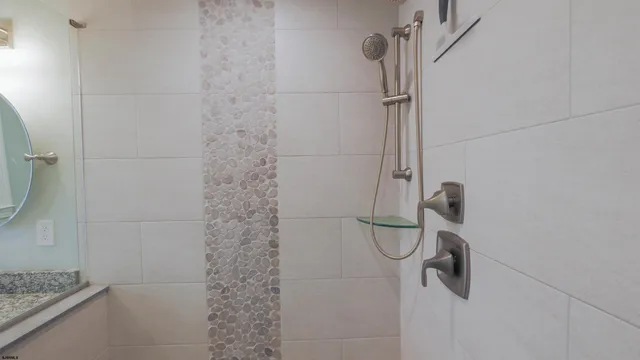 a bathroom with a granite countertop shower