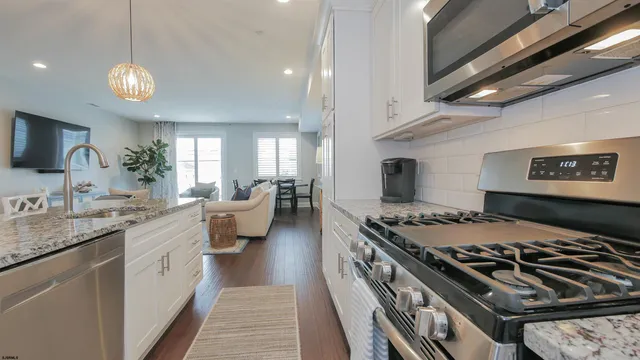 a kitchen with a stove and white cabinets