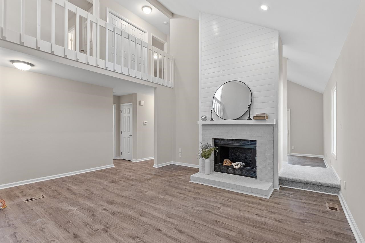 5516 Middleton Road Durham, NC 27713 - Photo 11 of 35 a view of an empty room with wooden floor fireplace and a window