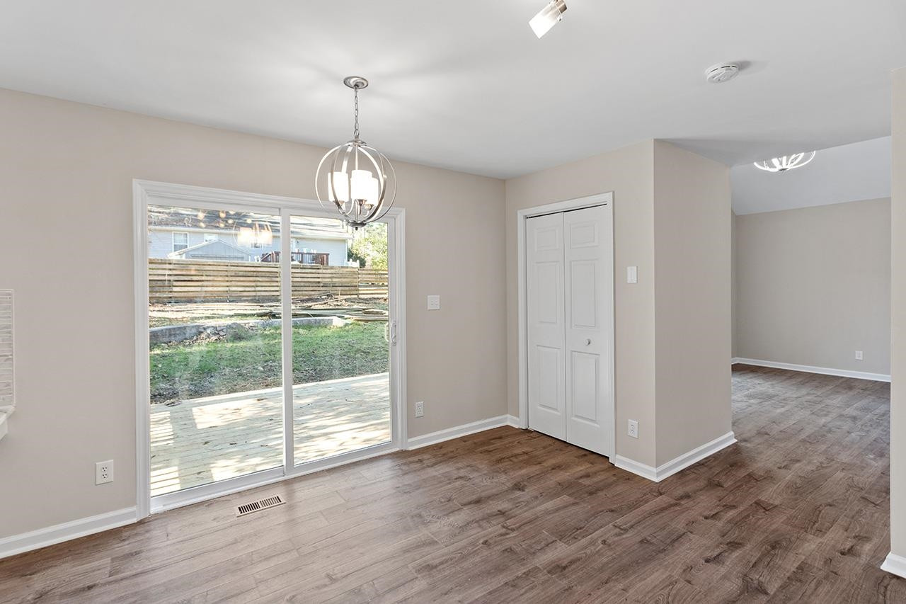 5516 Middleton Road Durham, NC 27713 - Photo 13 of 35 an empty room with wooden floor and windows