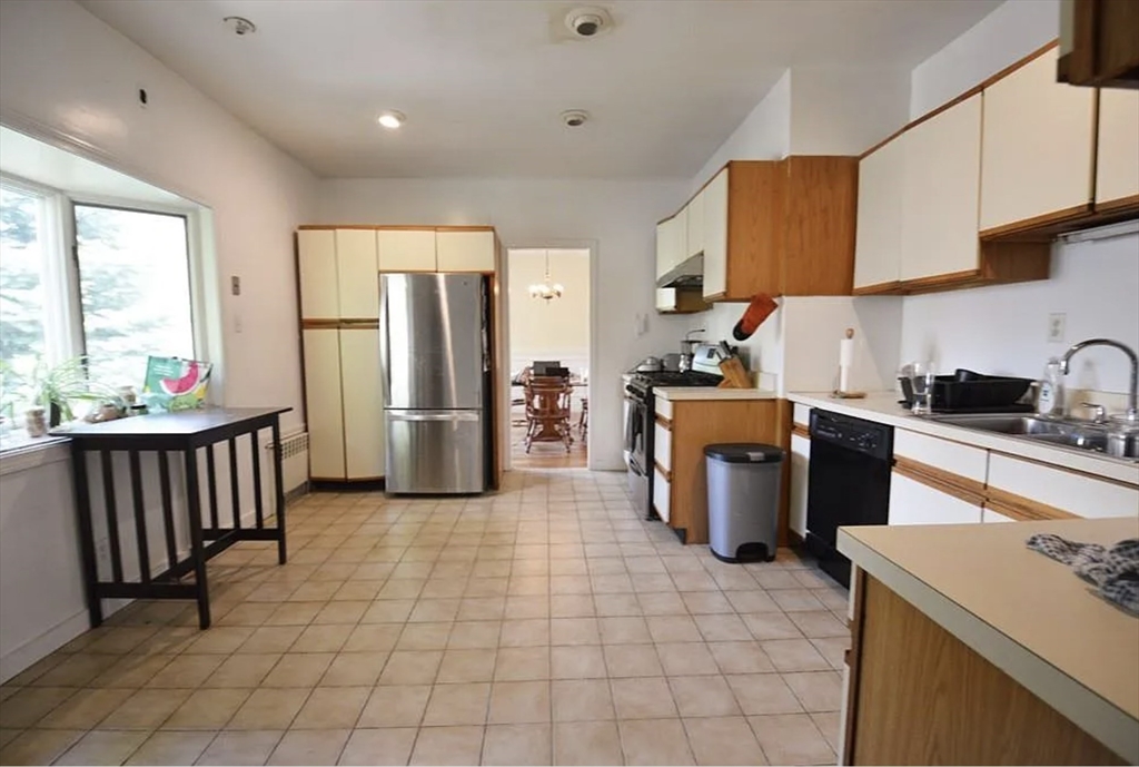 244 Winchester Street, Unit 2 Brookline, MA 02446 - Photo 1 of 4 a kitchen with refrigerator and cabinets
