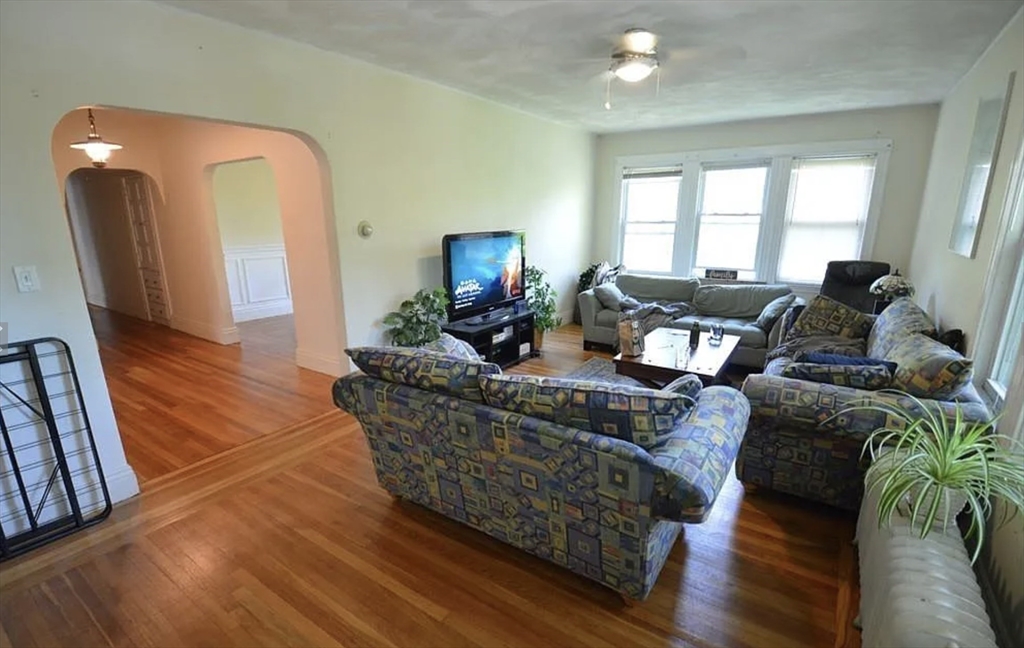 244 Winchester Street, Unit 2 Brookline, MA 02446 - Photo 2 of 4 a living room with furniture and a fireplace