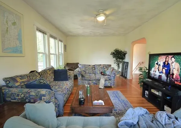 a living room with furniture and a flat screen tv