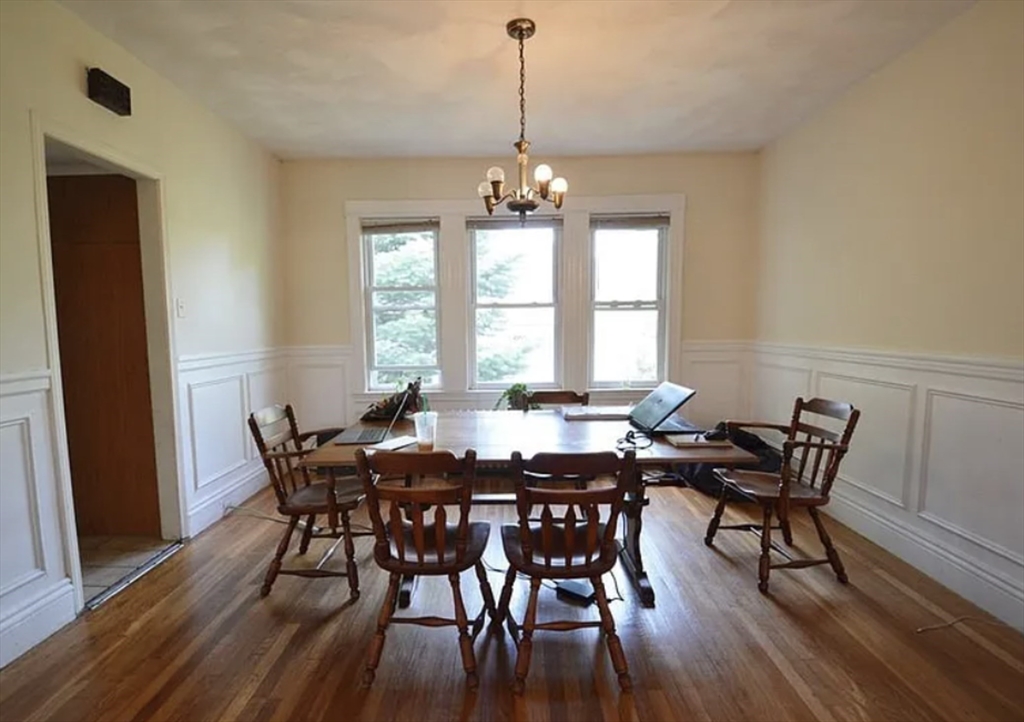 244 Winchester Street, Unit 2 Brookline, MA 02446 - Photo 4 of 4 a view of a dining room with furniture window and wooden floor