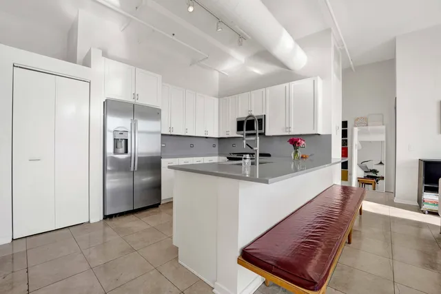 a bedroom with a large bed and a large window