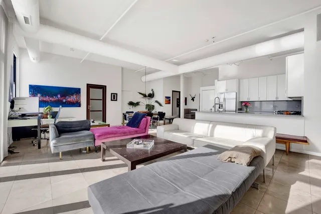 a living room with furniture and kitchen view