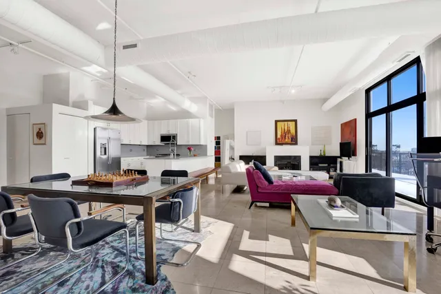 a living room with stainless steel appliances kitchen island granite countertop furniture and a view of kitchen