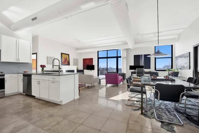 a kitchen with cabinets and chairs