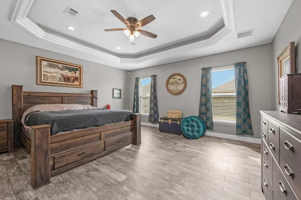 a bedroom with a bed and a television