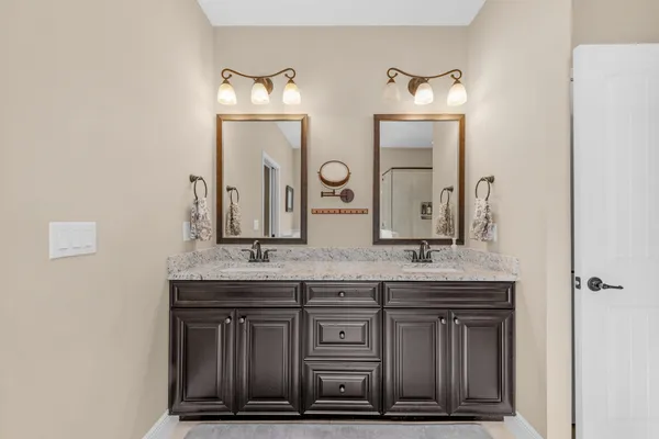 a bathroom with a granite countertop sink and a mirror