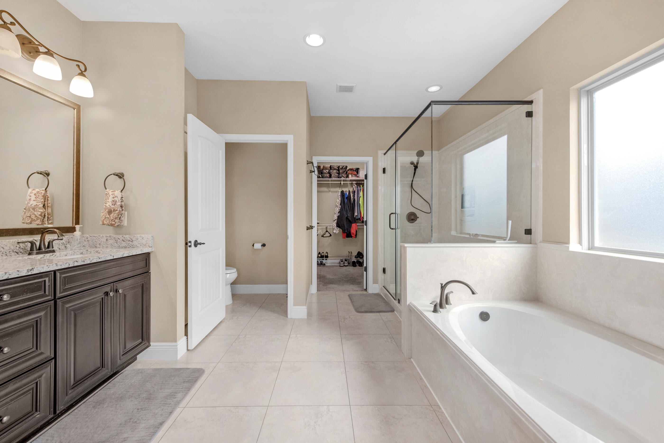 2394 Ellison Way Fort Walton Beach, FL 32547 - Photo 15 of 28 a bathroom with a tub a sink a mirror and a shower