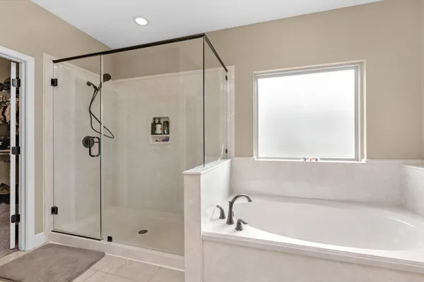 a bathroom with a shower and a tub