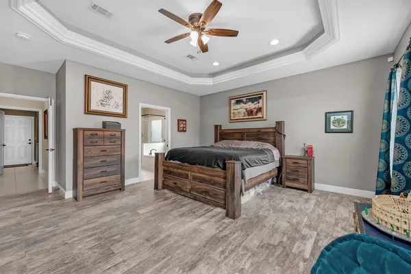 a bedroom with a bed and a view of room