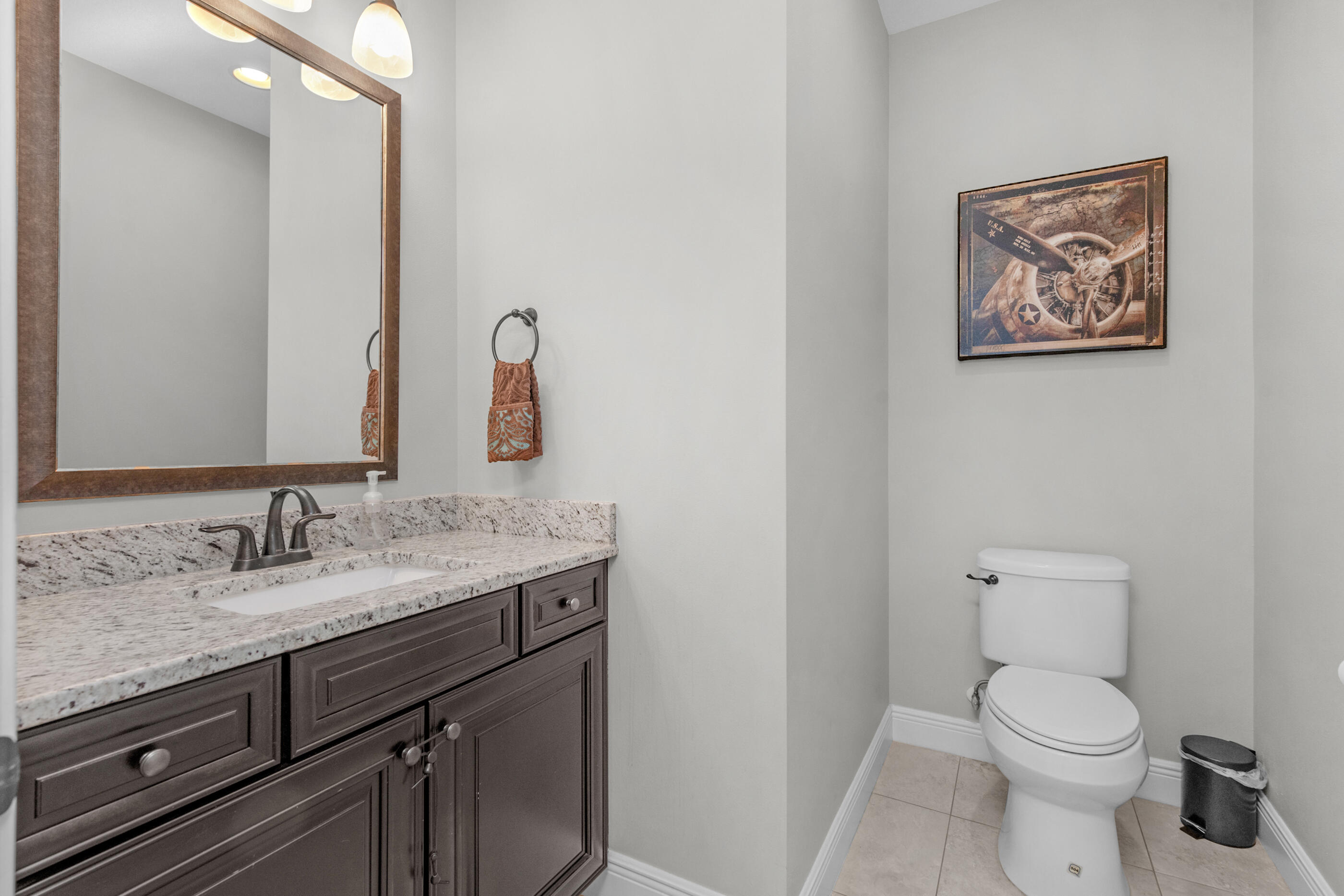 2394 Ellison Way Fort Walton Beach, FL 32547 - Photo 19 of 28 a bathroom with a granite countertop toilet sink and mirror