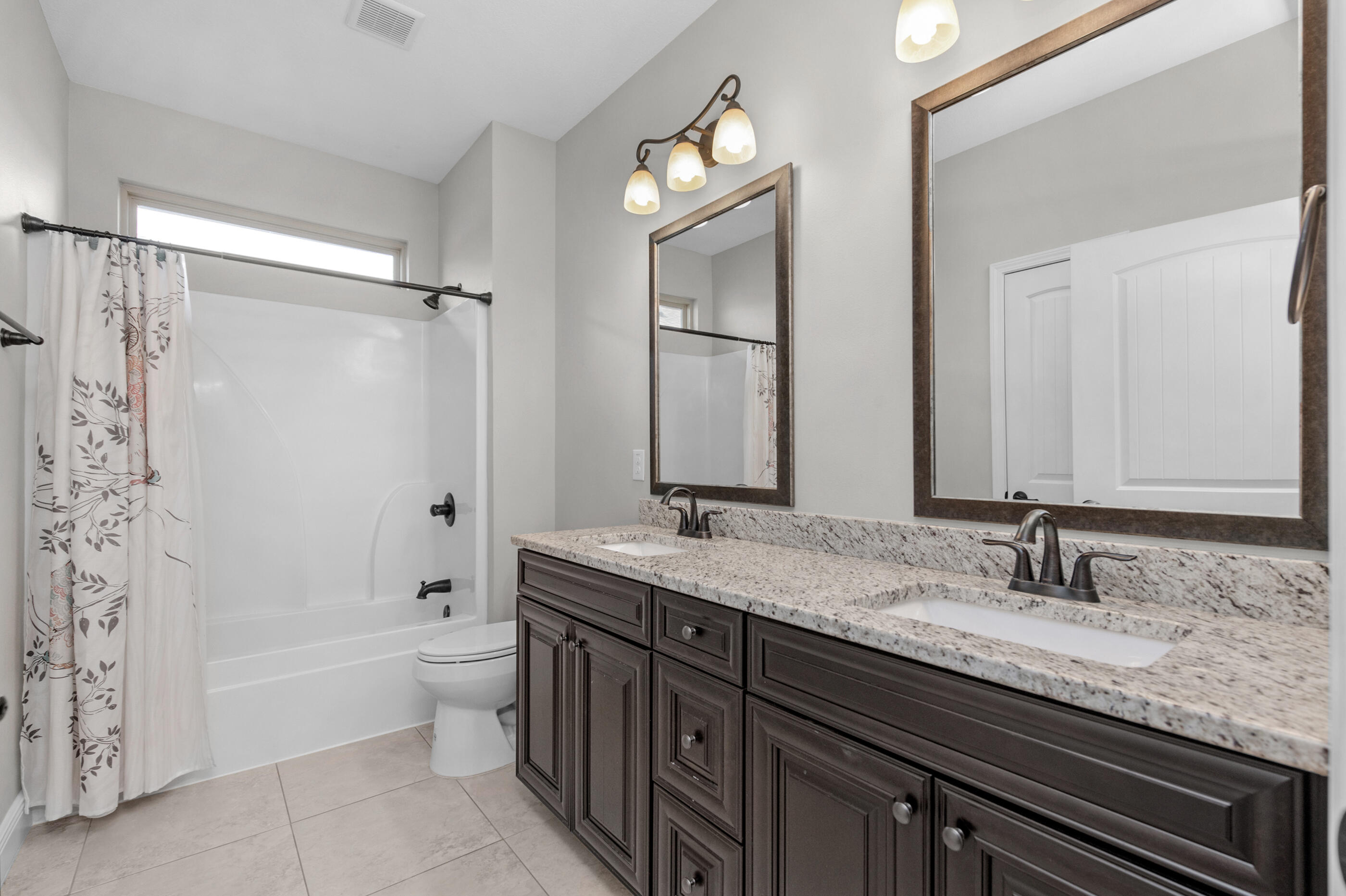 2394 Ellison Way Fort Walton Beach, FL 32547 - Photo 21 of 28 a bathroom with a granite countertop sink a toilet and bathtub