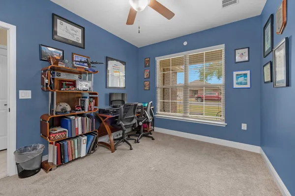a view of a livingroom with furniture and a large window