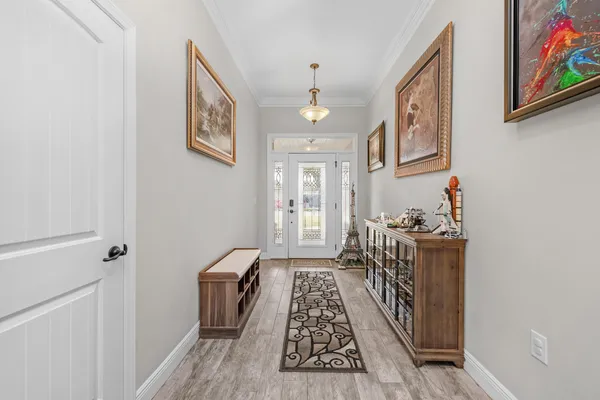 a hallway with furniture and wooden floor