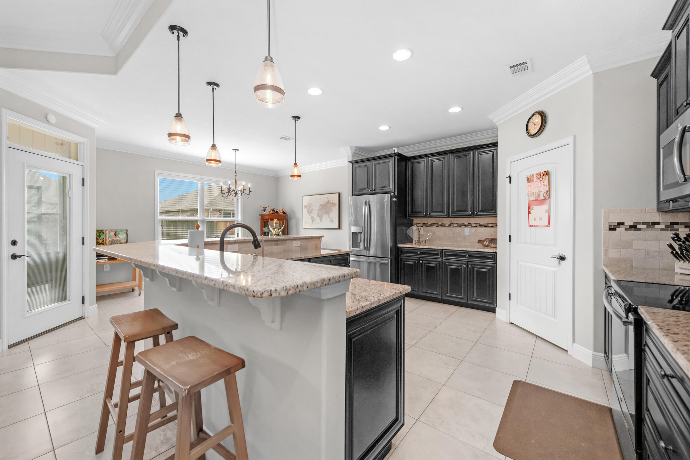 2394 Ellison Way Fort Walton Beach, FL 32547 - Photo 9 of 28 a kitchen with stainless steel appliances kitchen island granite countertop a sink and a refrigerator