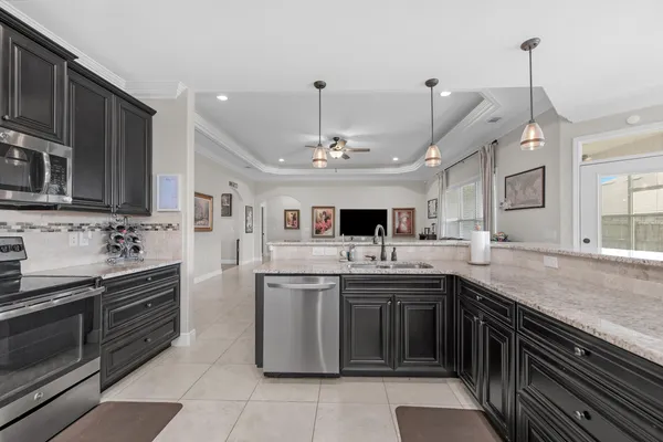 a kitchen with stainless steel appliances a sink stove and cabinets
