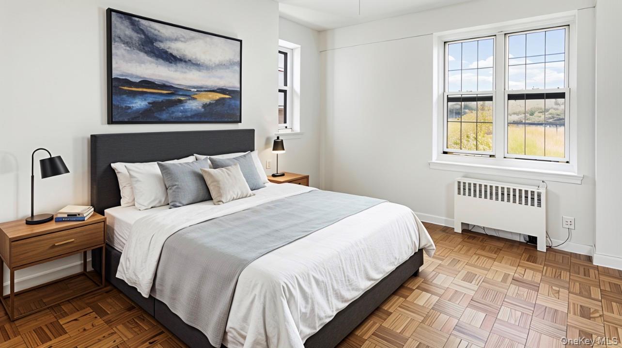 a bedroom with a bed and a painting on the wall