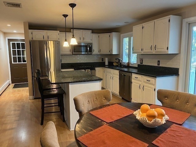 220 Erin Road Taunton, MA 02718 - Photo 13 of 42 a kitchen with stainless steel appliances kitchen island granite countertop a refrigerator and microwave