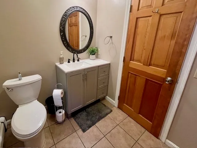 a bathroom with a toilet a sink and a mirror